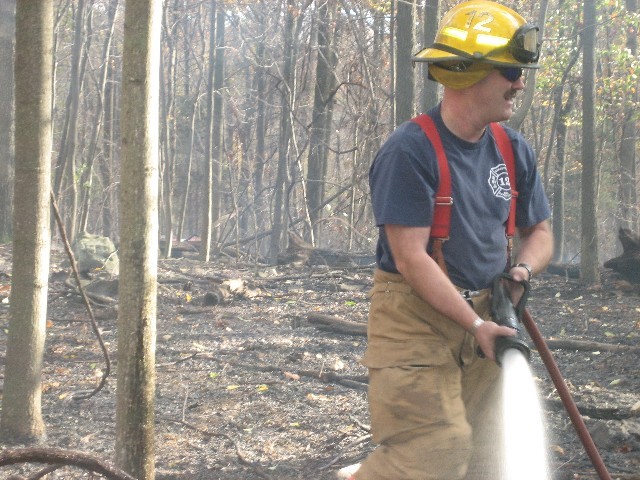 Firefighter Tom "Wild Nozzle" White hosing down hot spots (and firefighters!)